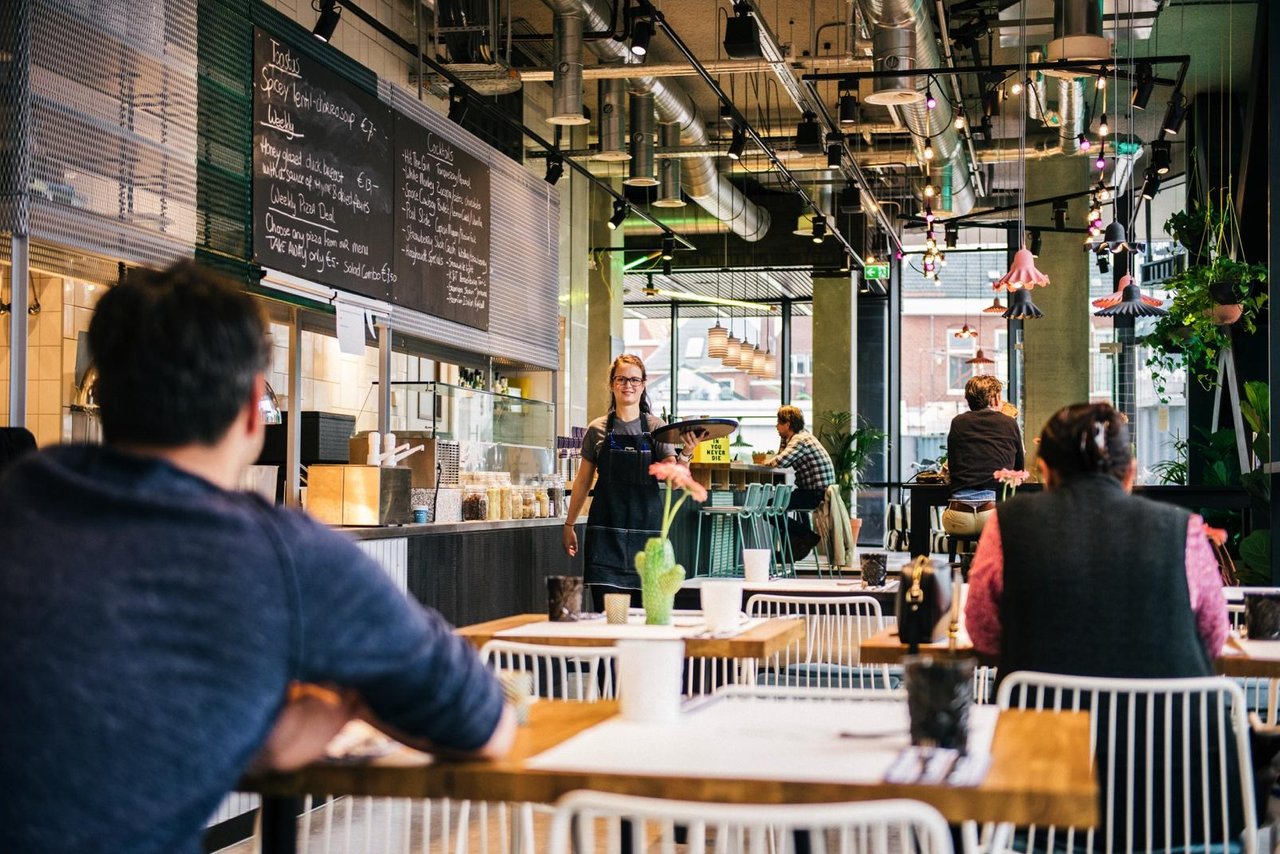 Server in the restaurant walking up to the table to take order.